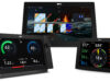 LightHouse 5 – Shame on you Raymarine! Three Raymarine Axiom 2 chartplotter displays running LightHouse 5: a large display showing the Home screen app grid, a display with an electric-propulsion battery and power dashboard, and a display showing sailing data with a wind and heading compass.