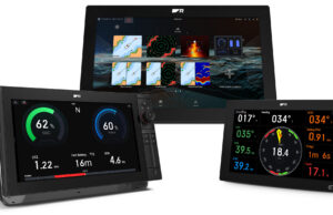 LightHouse 5 – Shame on you, Raymarine! Three Raymarine Axiom 2 chartplotter displays running LightHouse 5: a large display showing the Home screen app grid, a display with an electric-propulsion battery and power dashboard, and a display showing sailing data with a wind and heading compass.