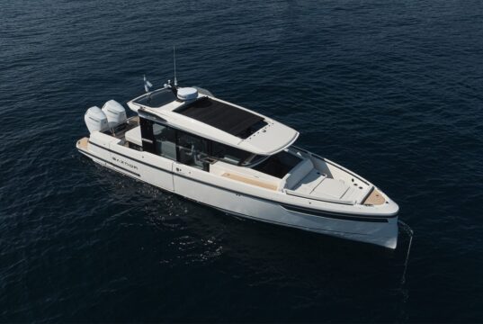 Saxdor Starts US Production, Adds 350 GTW at FLIBS Aerial view of the white Saxdor 350 GTW motorboat with twin Mercury outboards on dark blue water