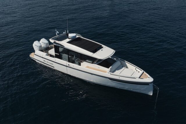 Aerial view of the white Saxdor 350 GTW motorboat with twin Mercury outboards on dark blue water