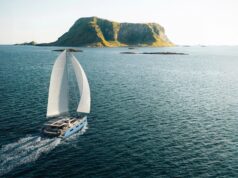 Vision 484: New 48ft Bluewater Catamaran Lands in 2027 Render of the Vision 484 catamaran under sail off a rocky headland